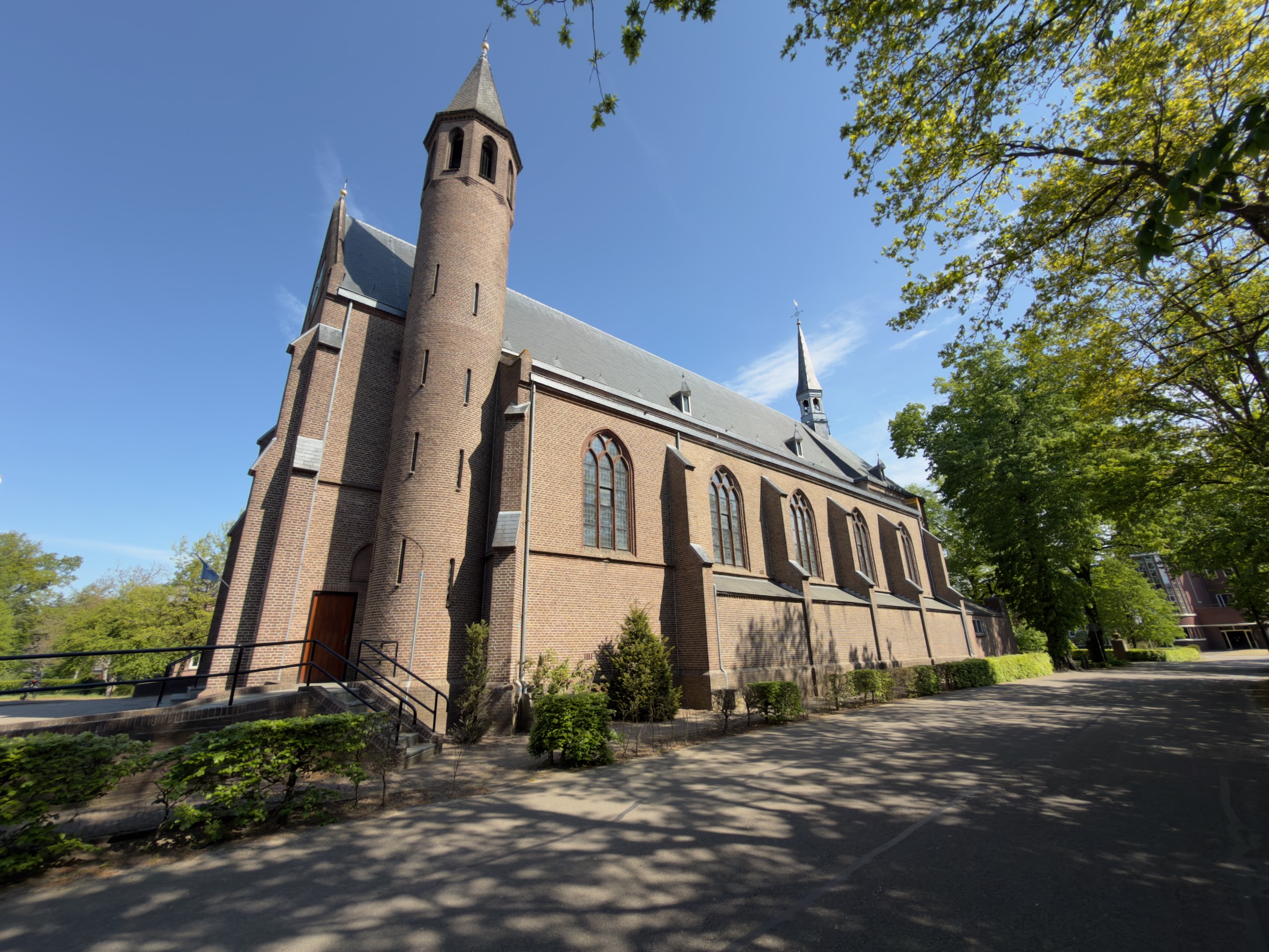 Side view of the brick Carmelite monastery church in Zenderen with its tall round tower