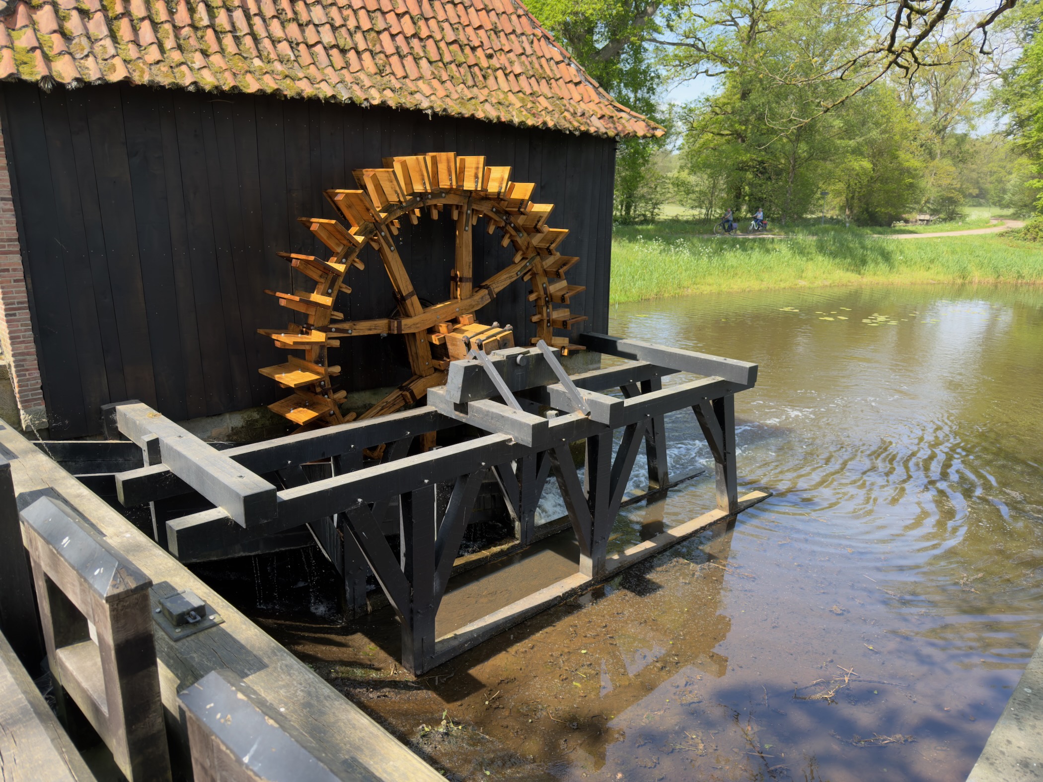 Wooden water mill with a large overshot wheel beside the Twickeler Vaart canal
