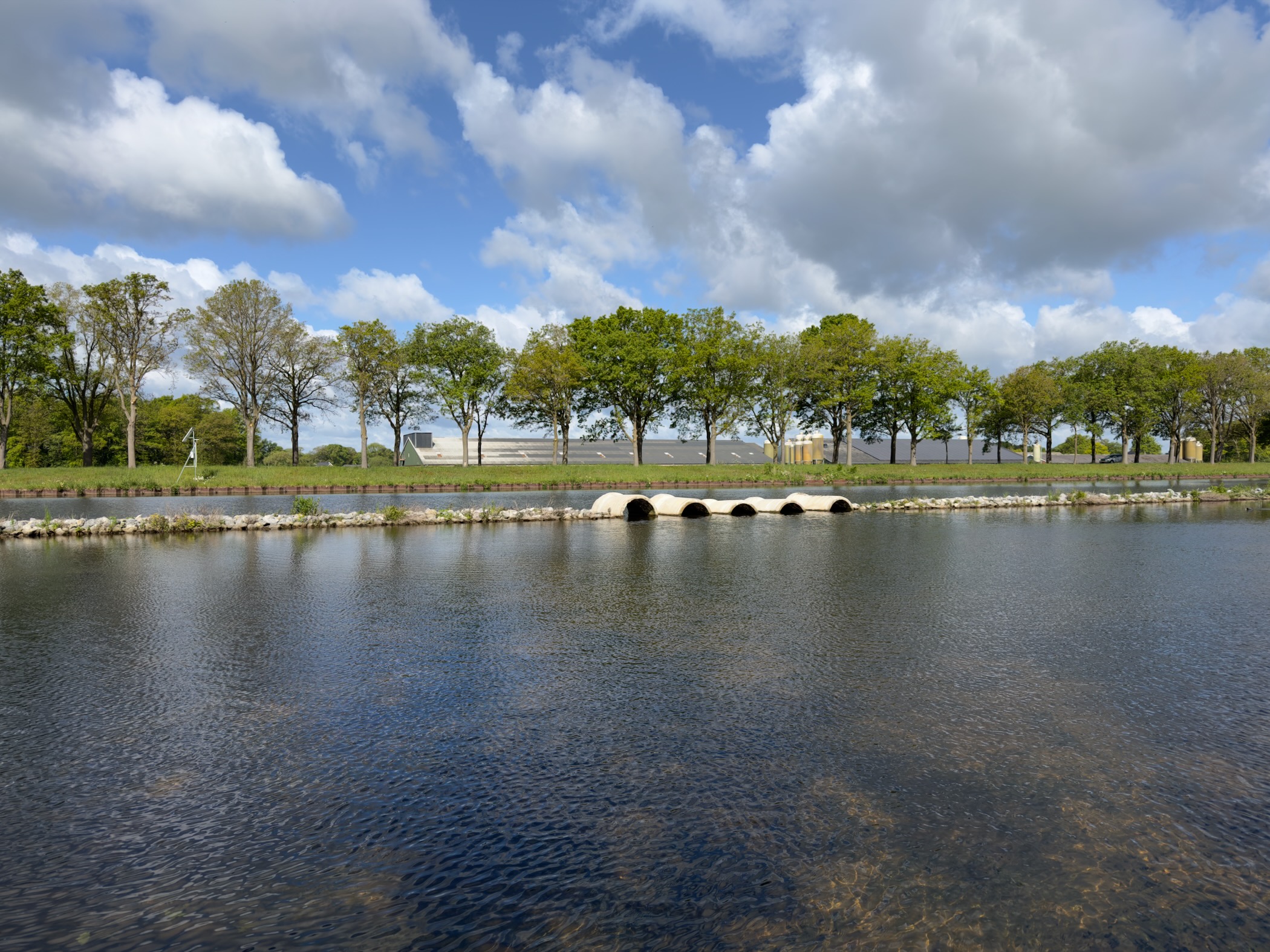 View across the Twentekanaal with a row of stepping stones spanning the water