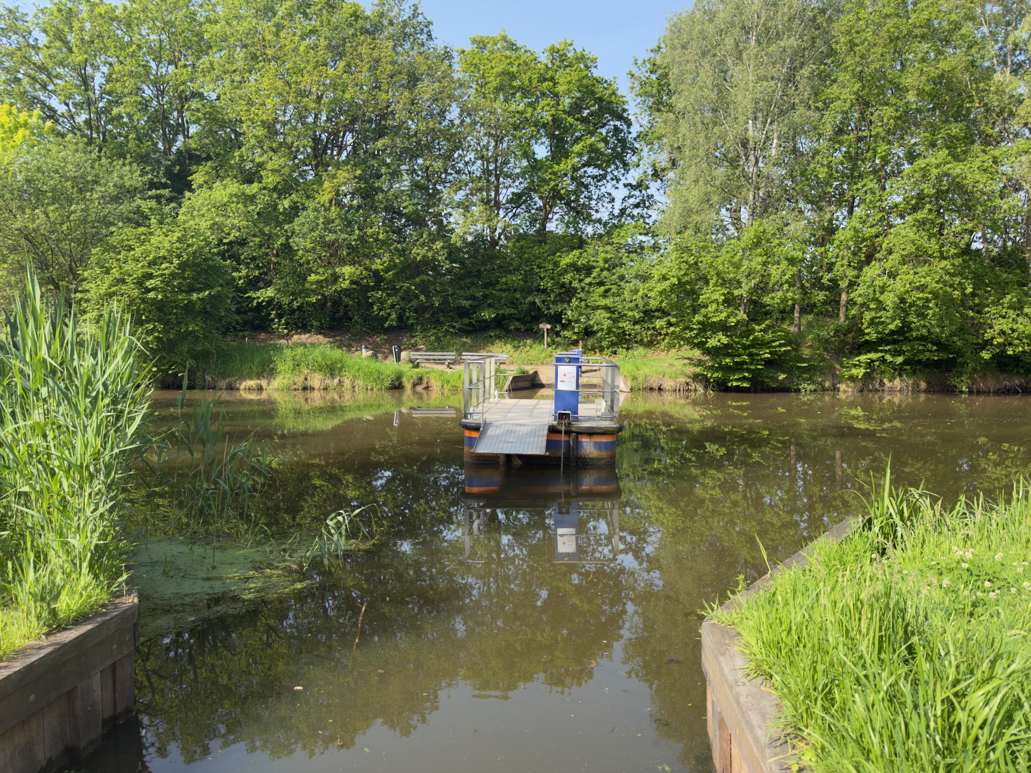 Self-service cable ferry waiting on the calm waters of the Regge