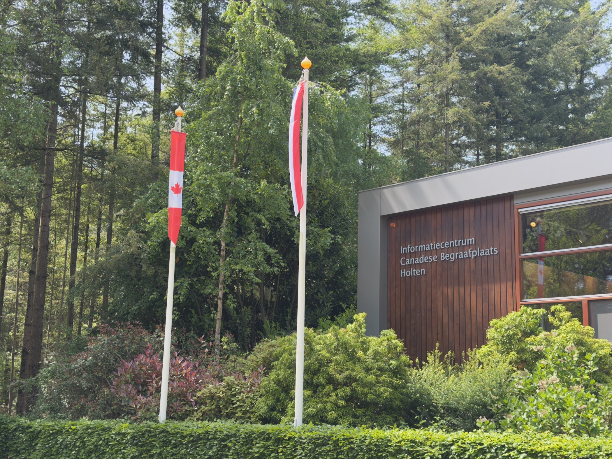 Canadian and Dutch flags outside the information centre for the Canadian War Cemetery at Holten