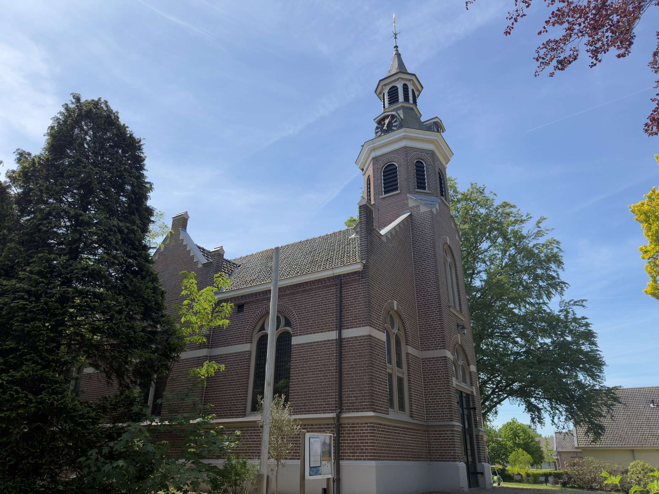 Brick village church of Okkenbroek with its tall slender spire