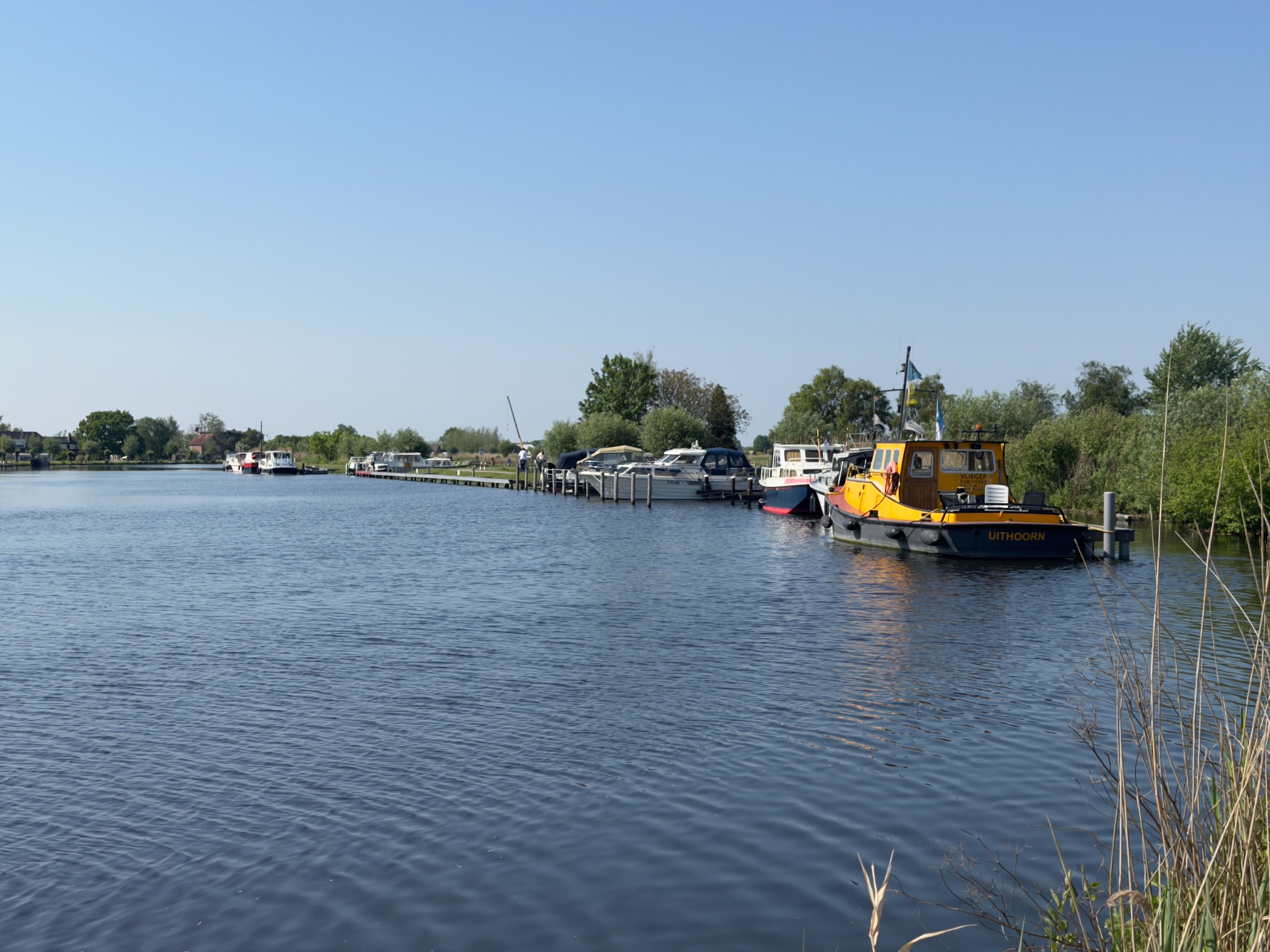 Marina on the Amstel with moored pleasure boats and a yellow tugboat named Uithoorn