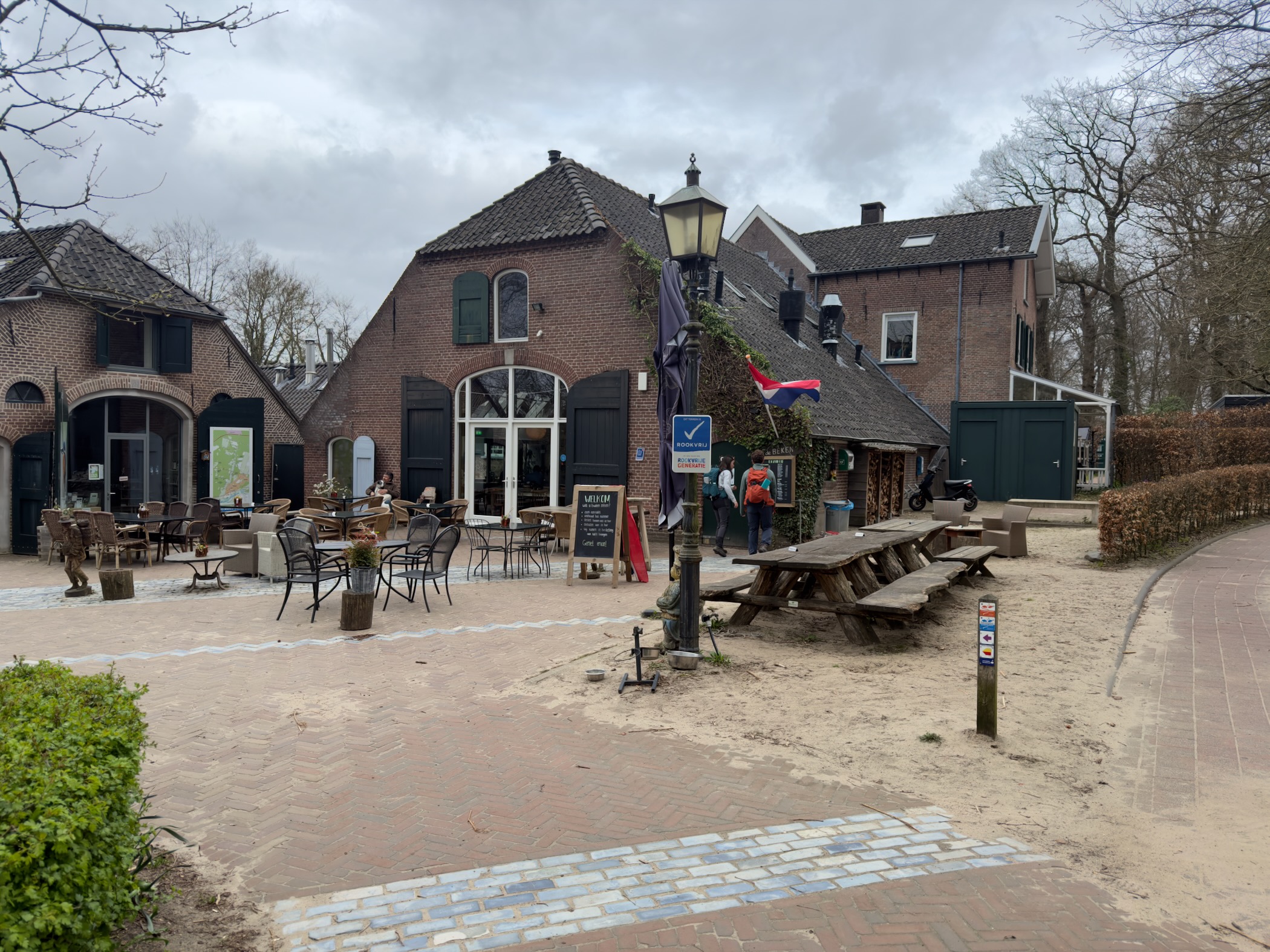 Village square with outdoor terrace seating at a traditional Dutch cafe