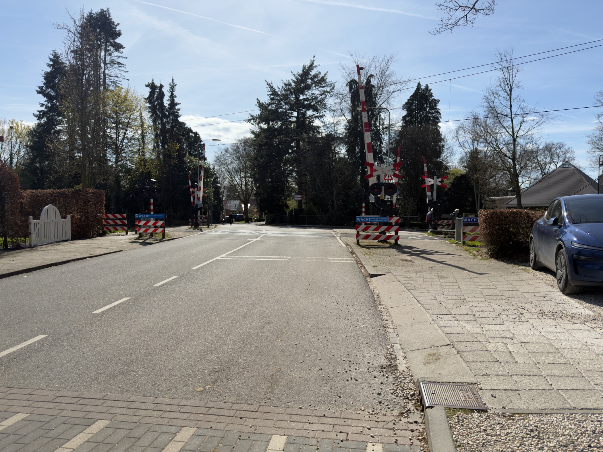 Railway level crossing with barriers and warning signals in Lunteren