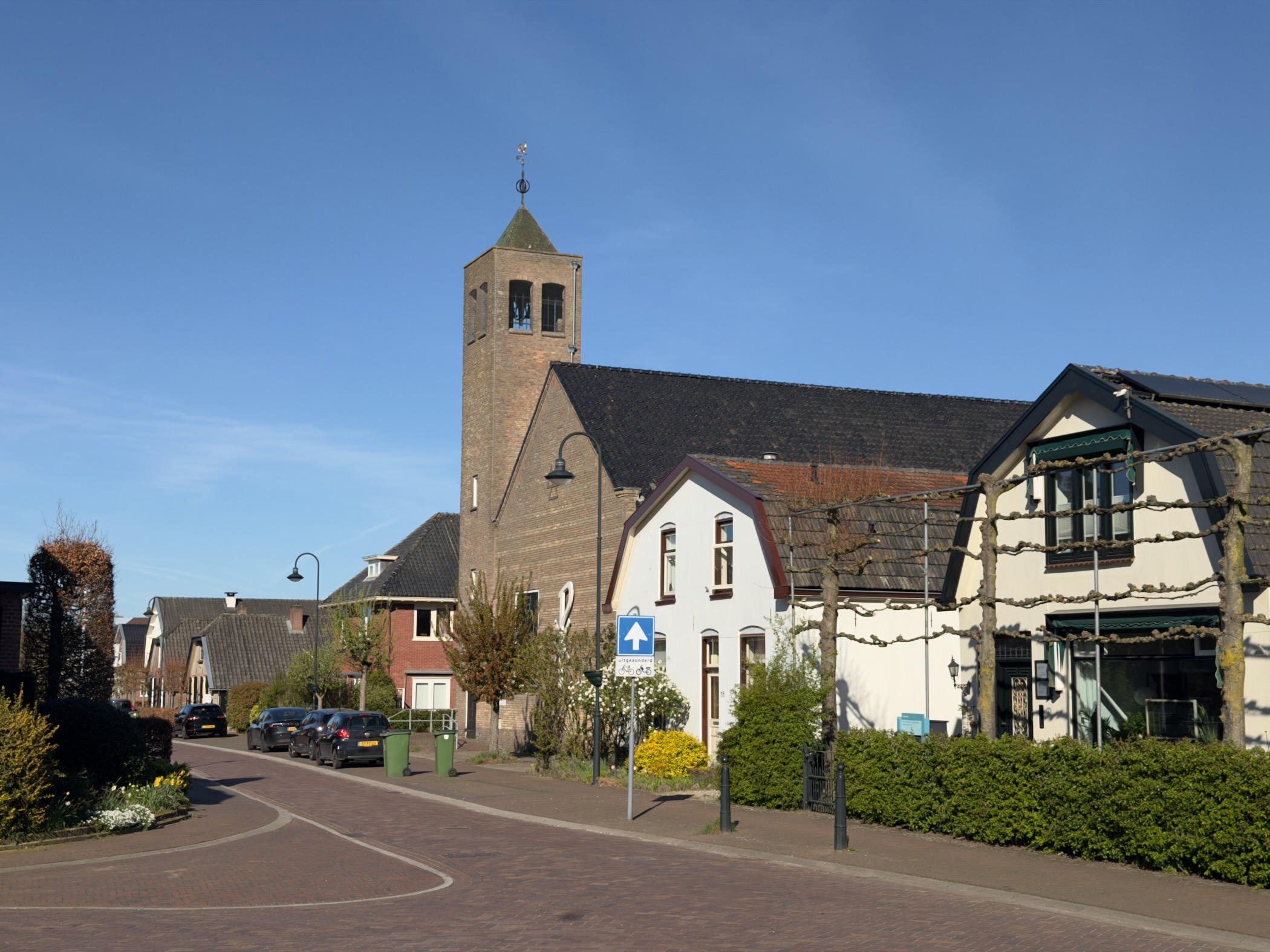Lunteren village street with the brick church and bell tower