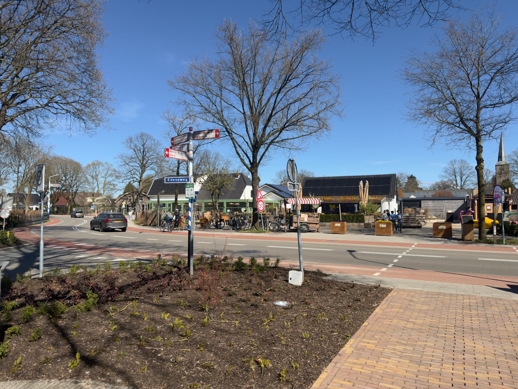 Otterlo village square with directional signposts and the church spire