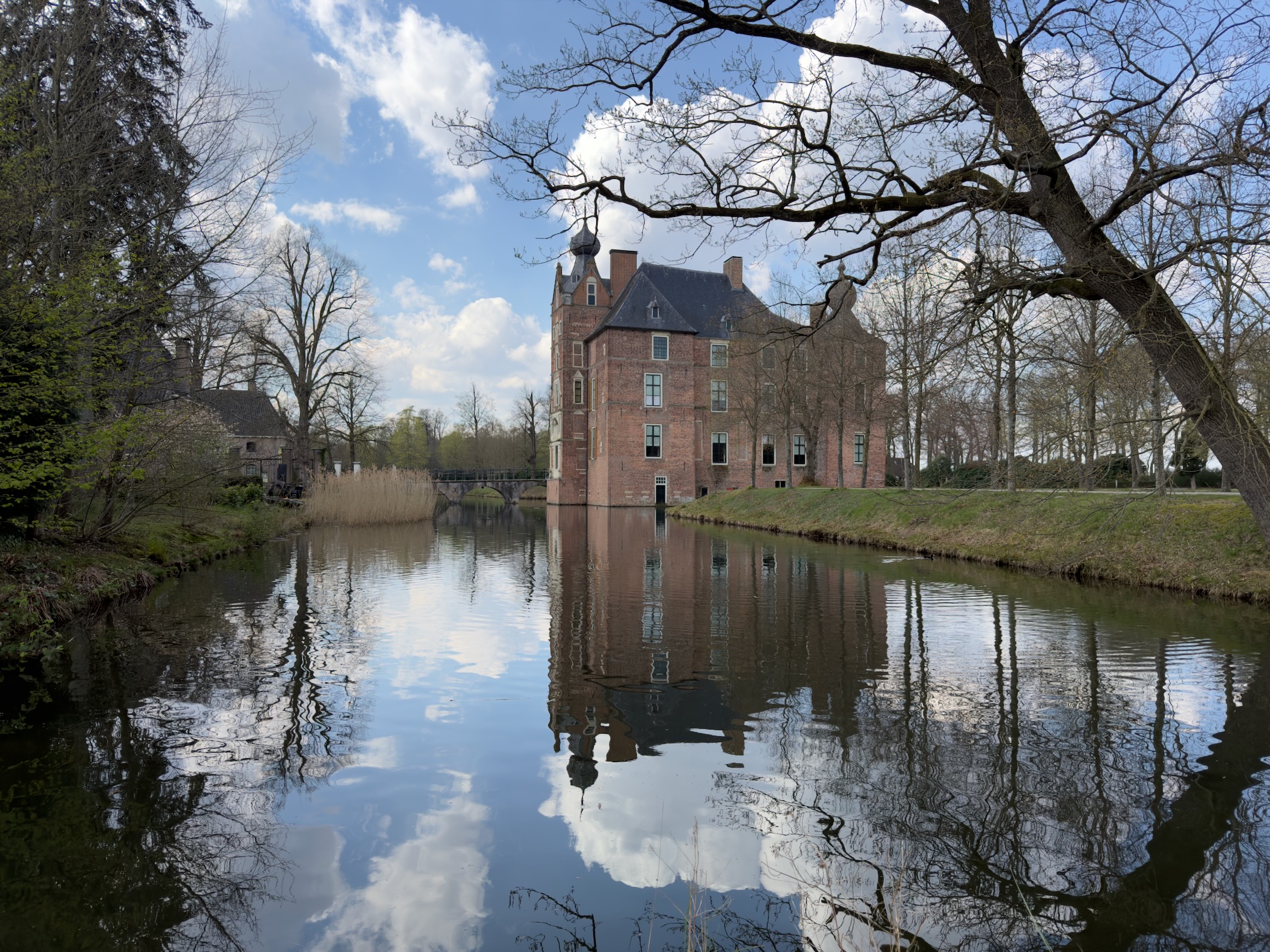 Castle seen from across the moat with dramatic cloud reflections in the water