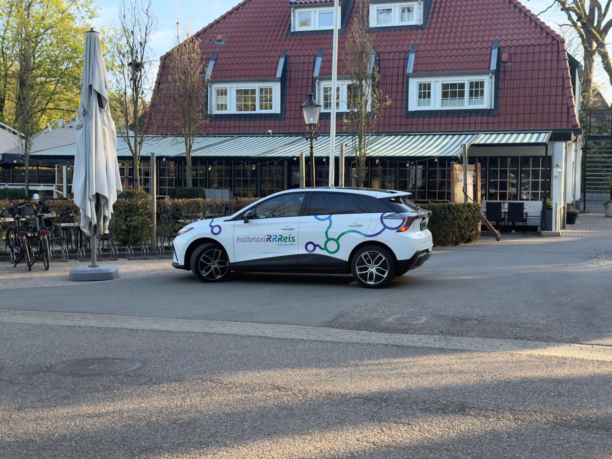 RRReis public transport car parked in front of a restaurant in Kootwijk
