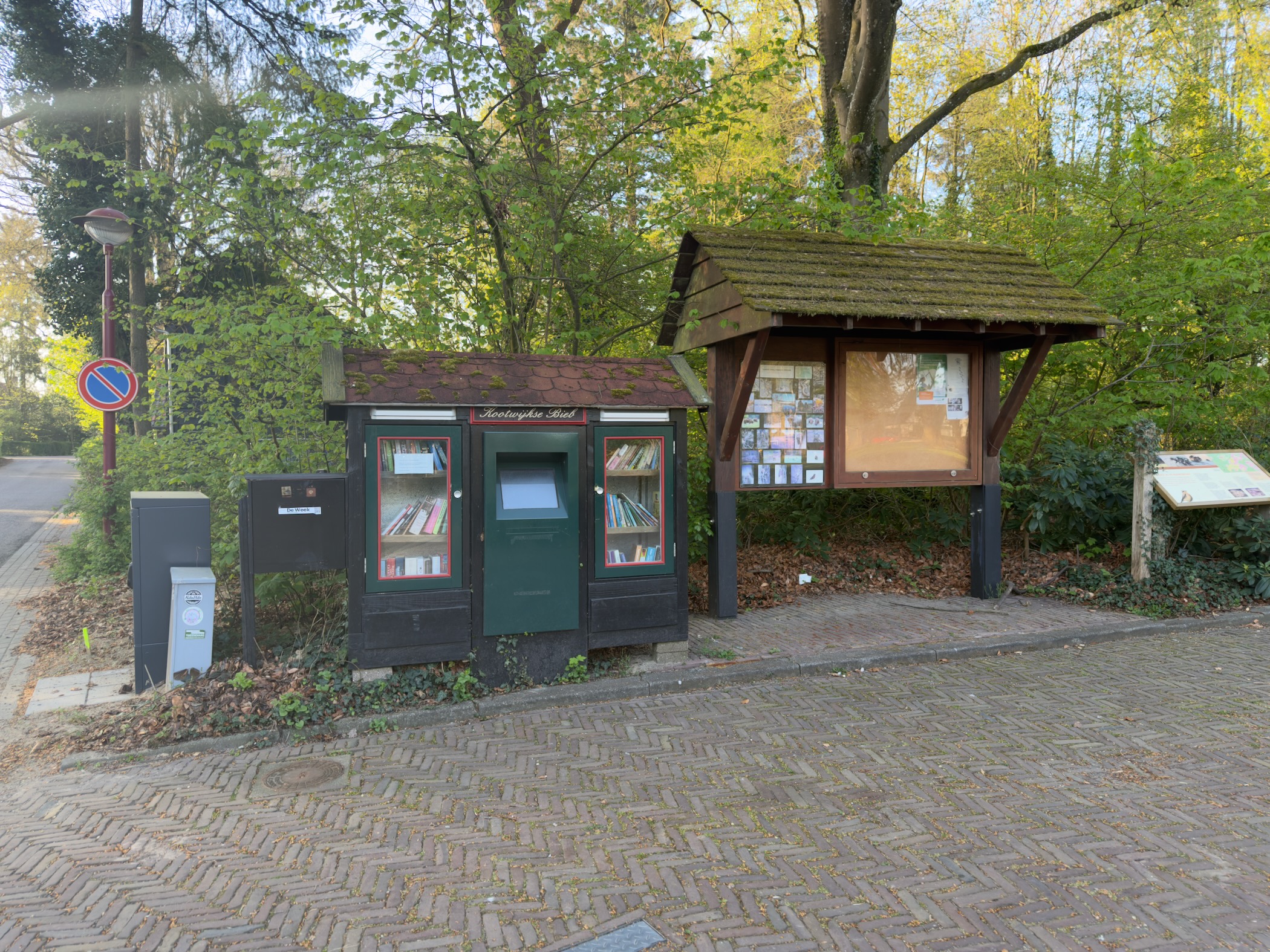 Small free library and information board at the edge of the forest in Kootwijk