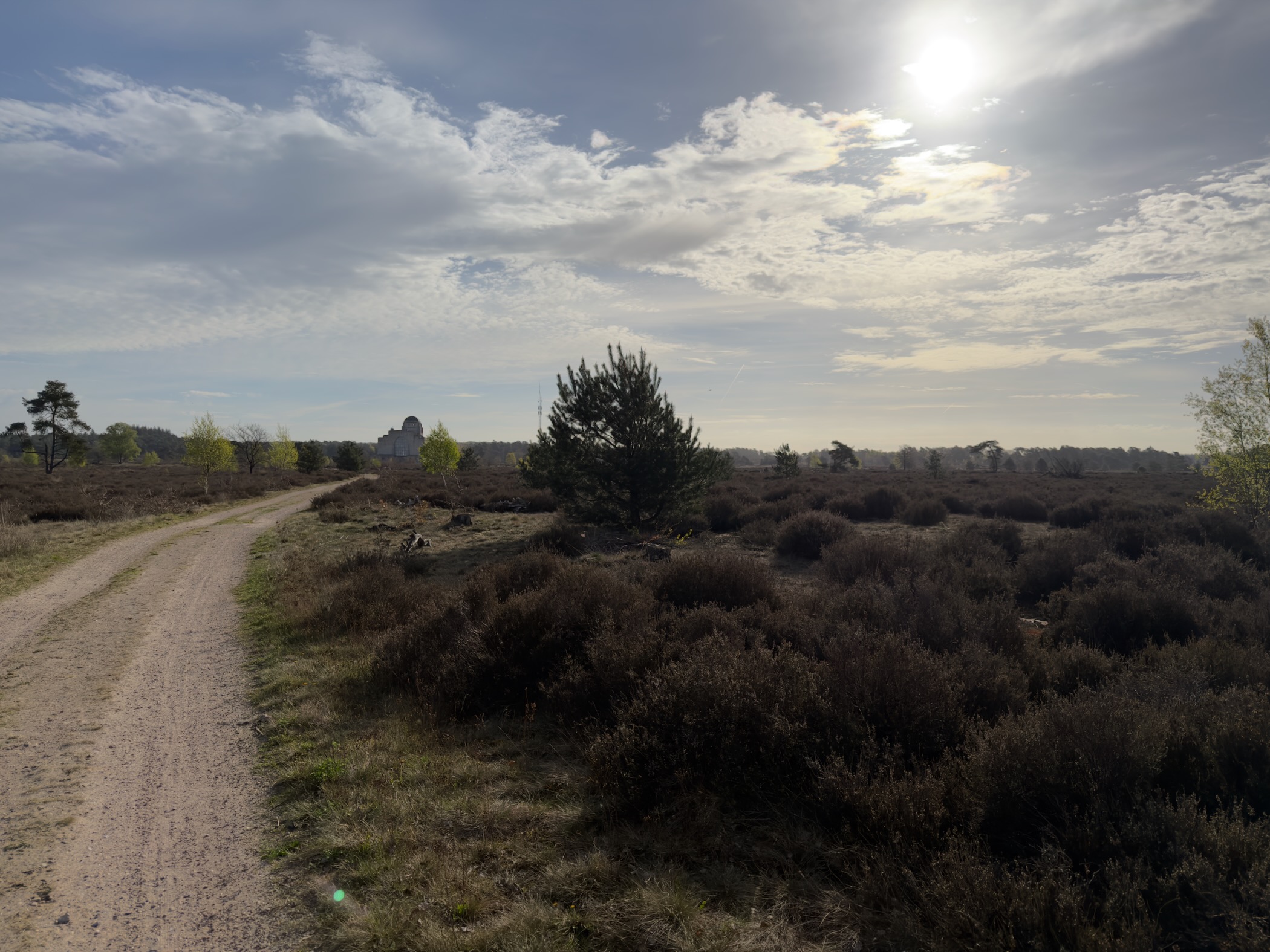 Sandy path through heathland with Radio Kootwijk building in the background