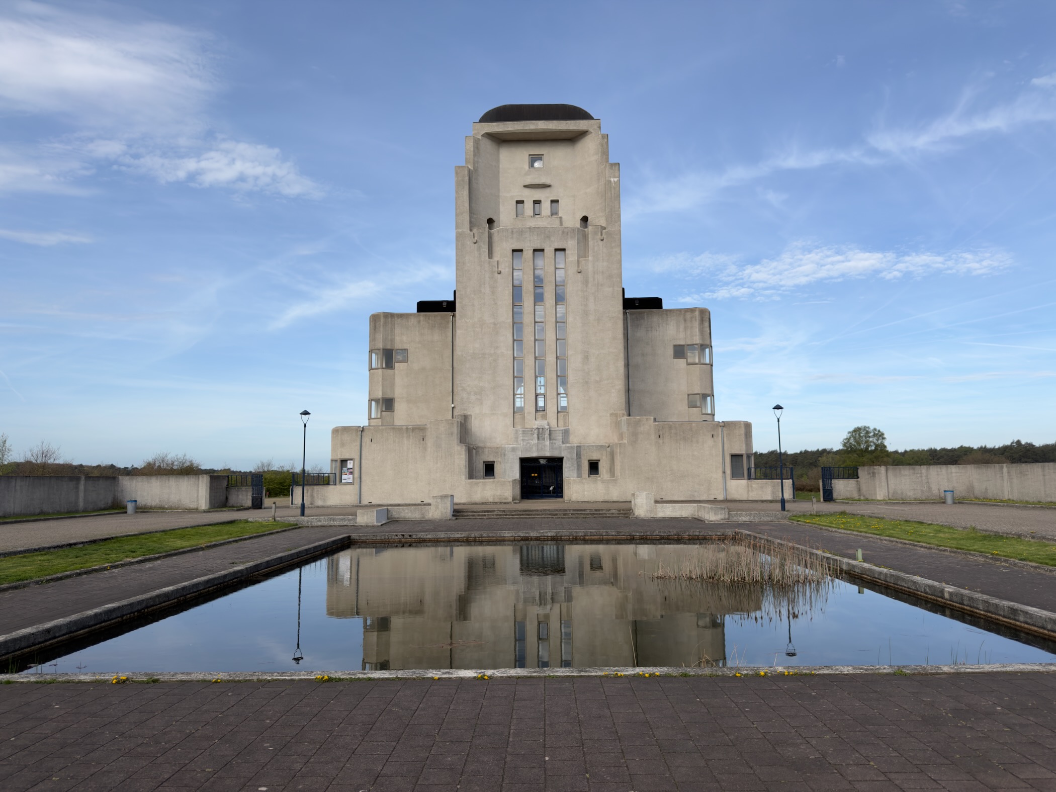 Radio Kootwijk main building reflected in the rectangular pond in front of it