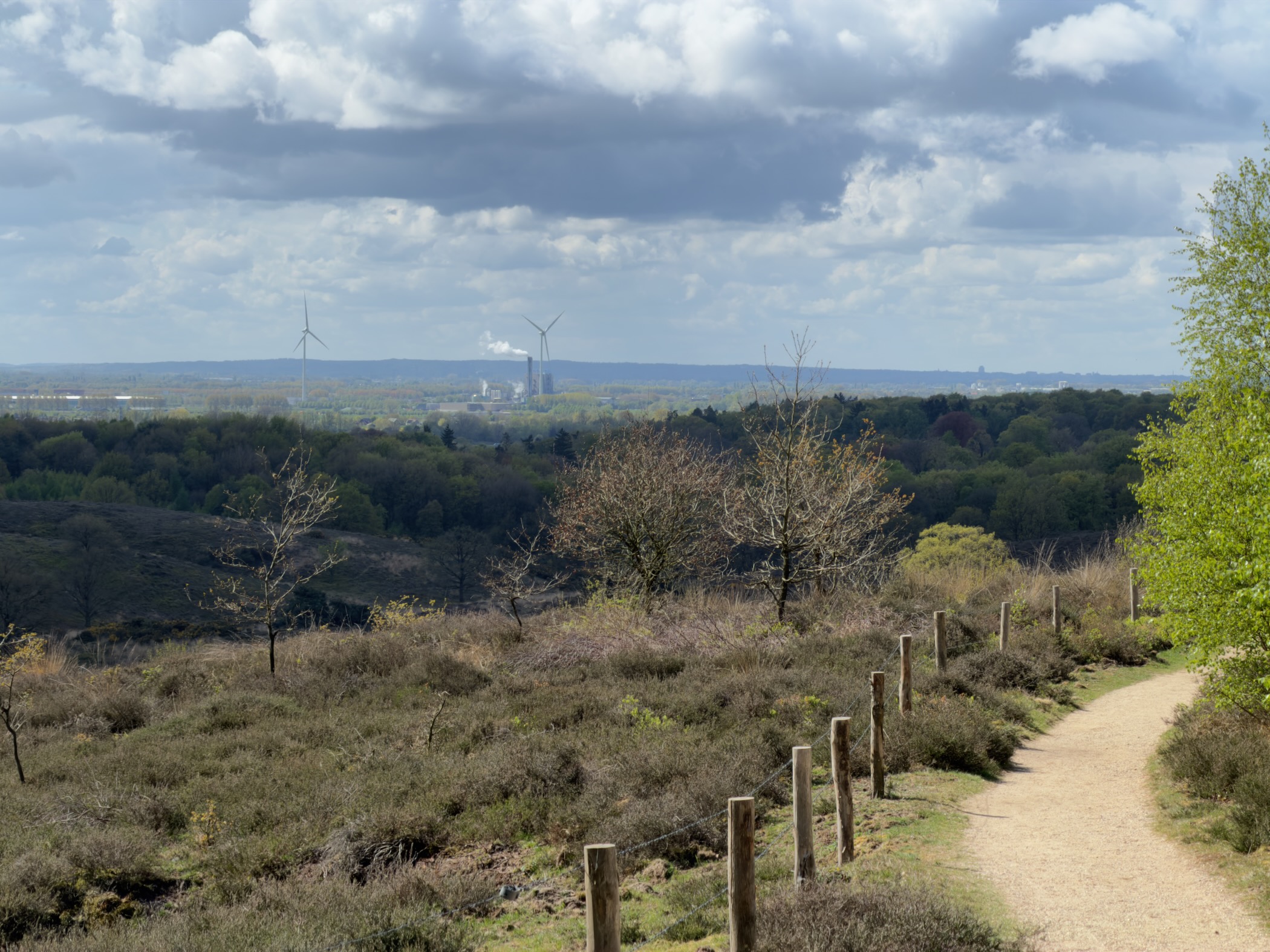Panorama from the Posbank across forests to a distant power station and wind turbines