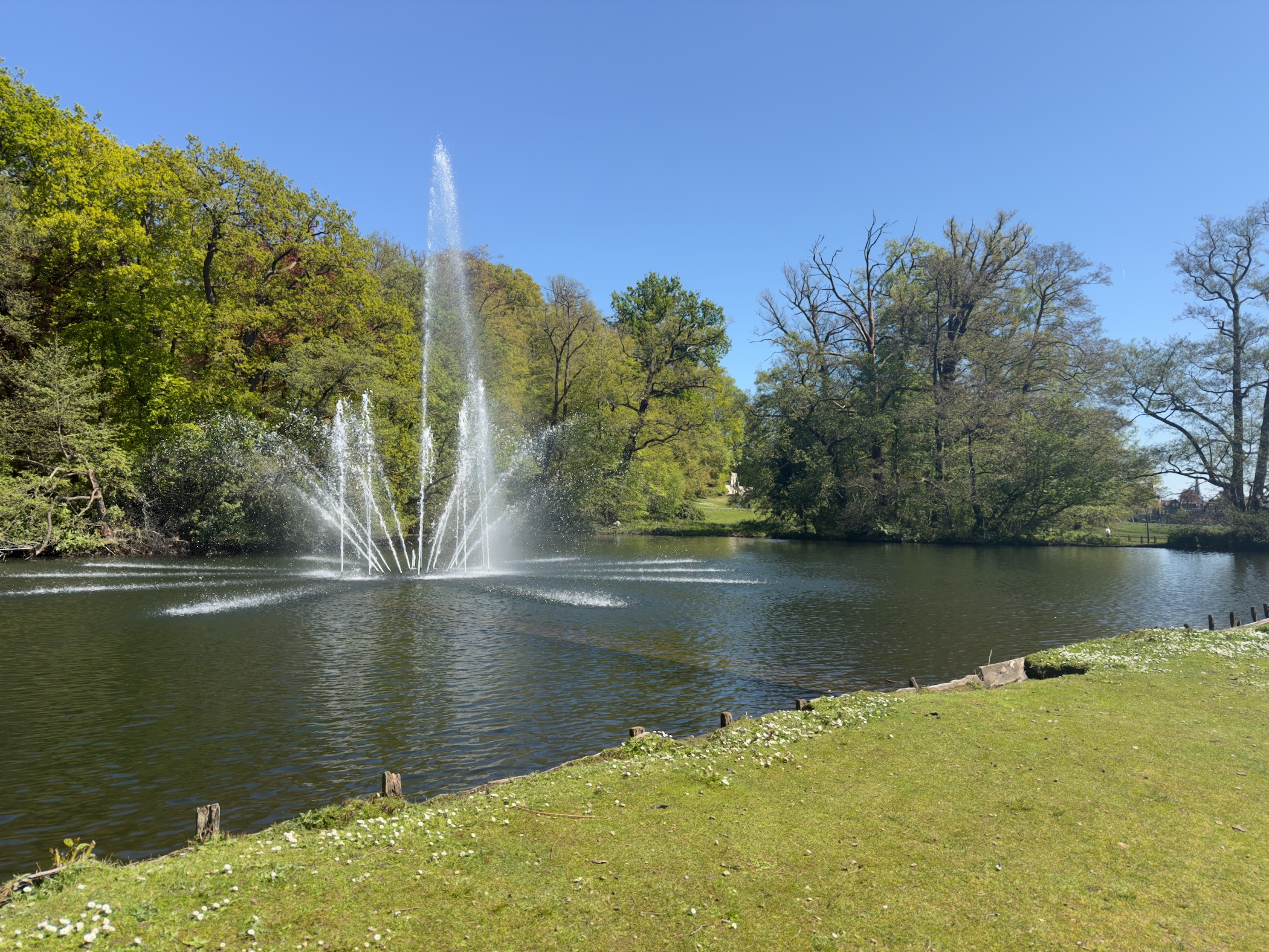 Tall fountain spraying jets of water in a pond in Sonsbeek park