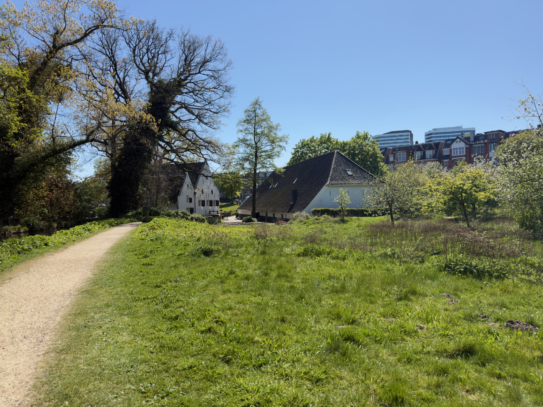 Historic white and brick houses in Sonsbeek park with Arnhem buildings behind