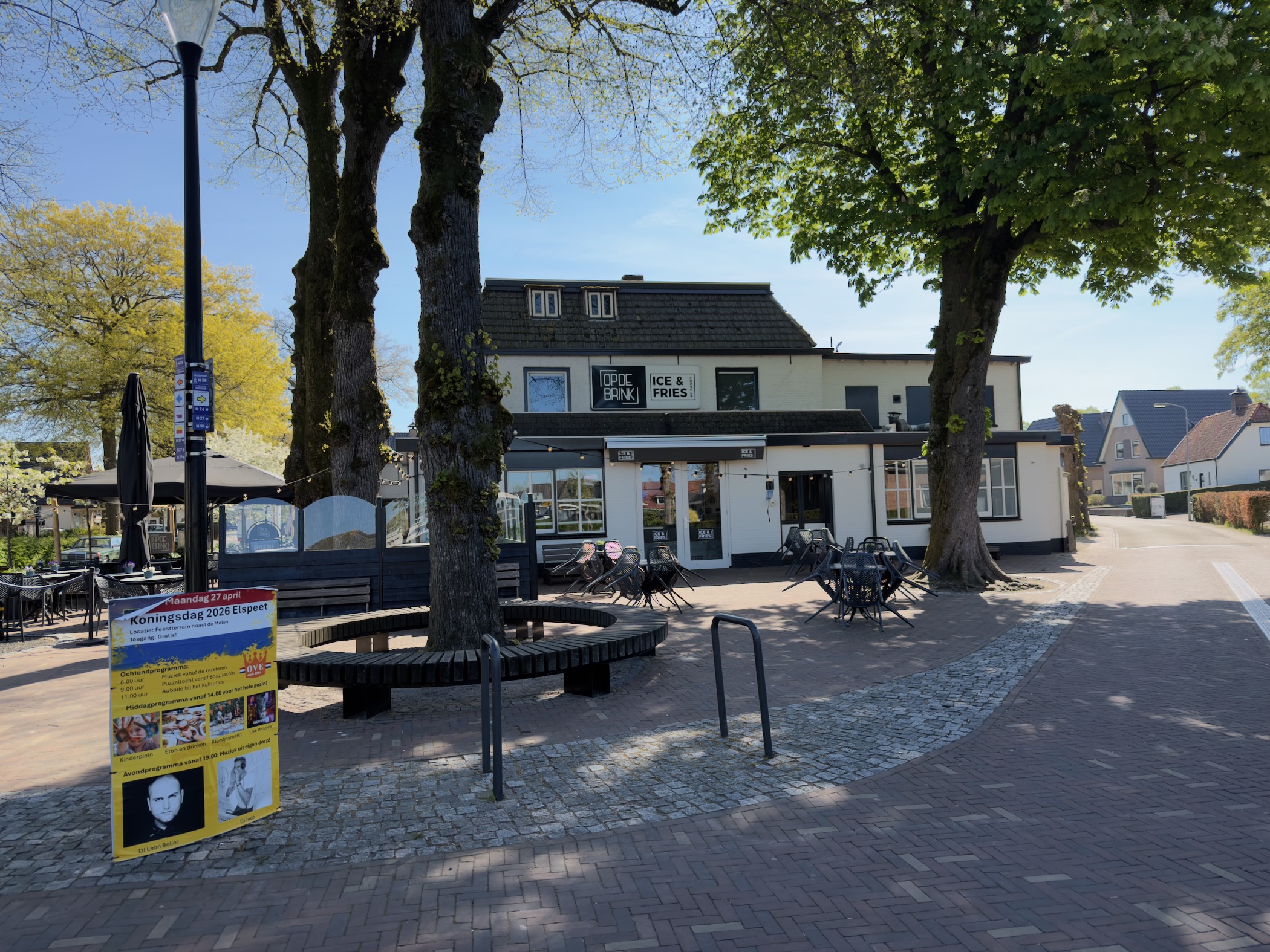 Elspeet village square with tall trees and the Ice & Fries ice cream shop at the start of the hike