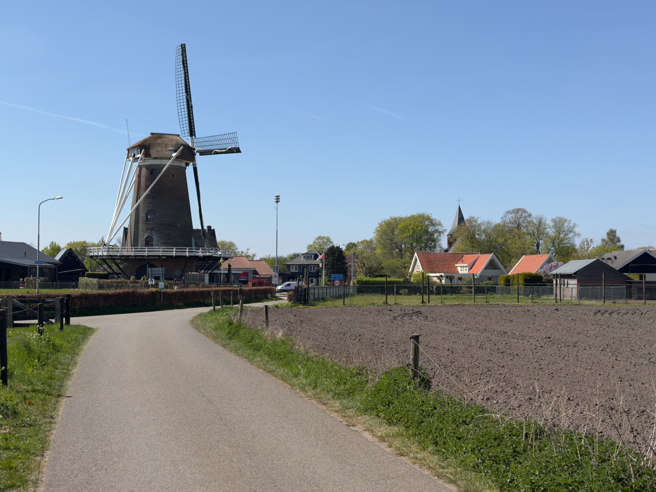 Windmill at Garderen with houses and a church behind
