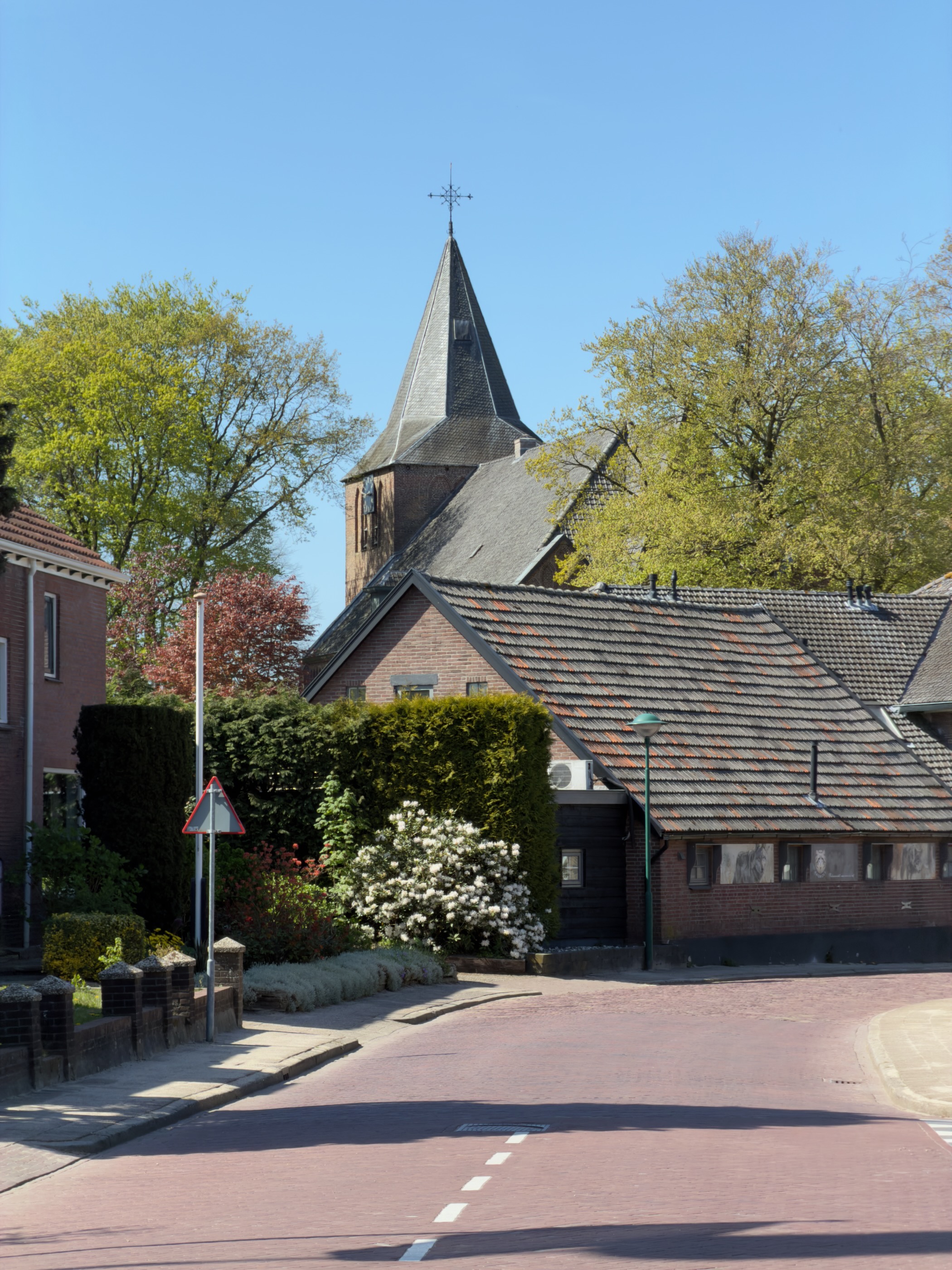 Red brick church with pointed tower in Garderen