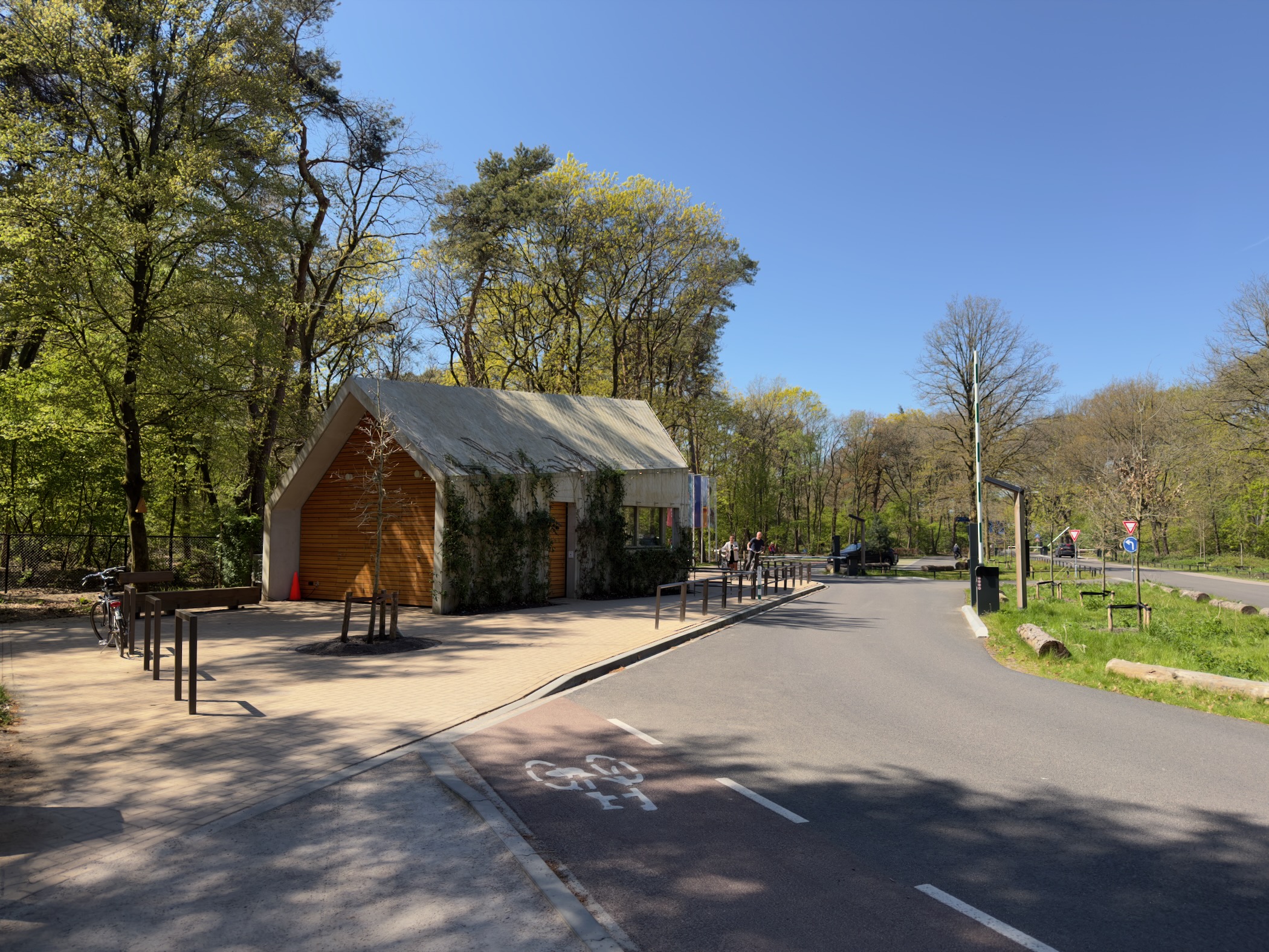 A wooden visitor building beside a cycle path