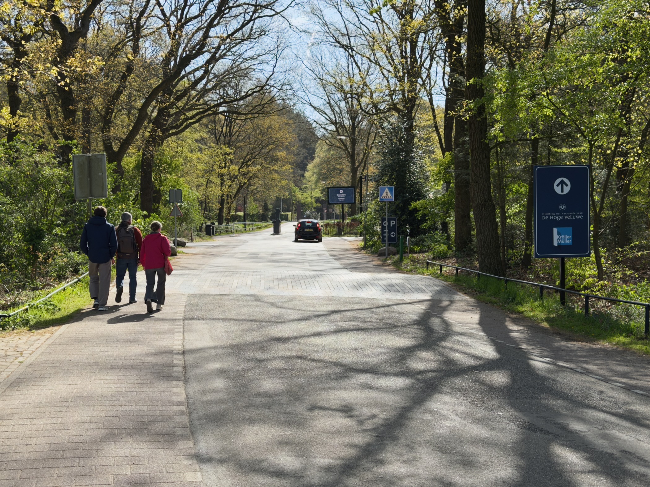 Walkers on the entrance road into De Hoge Veluwe National Park