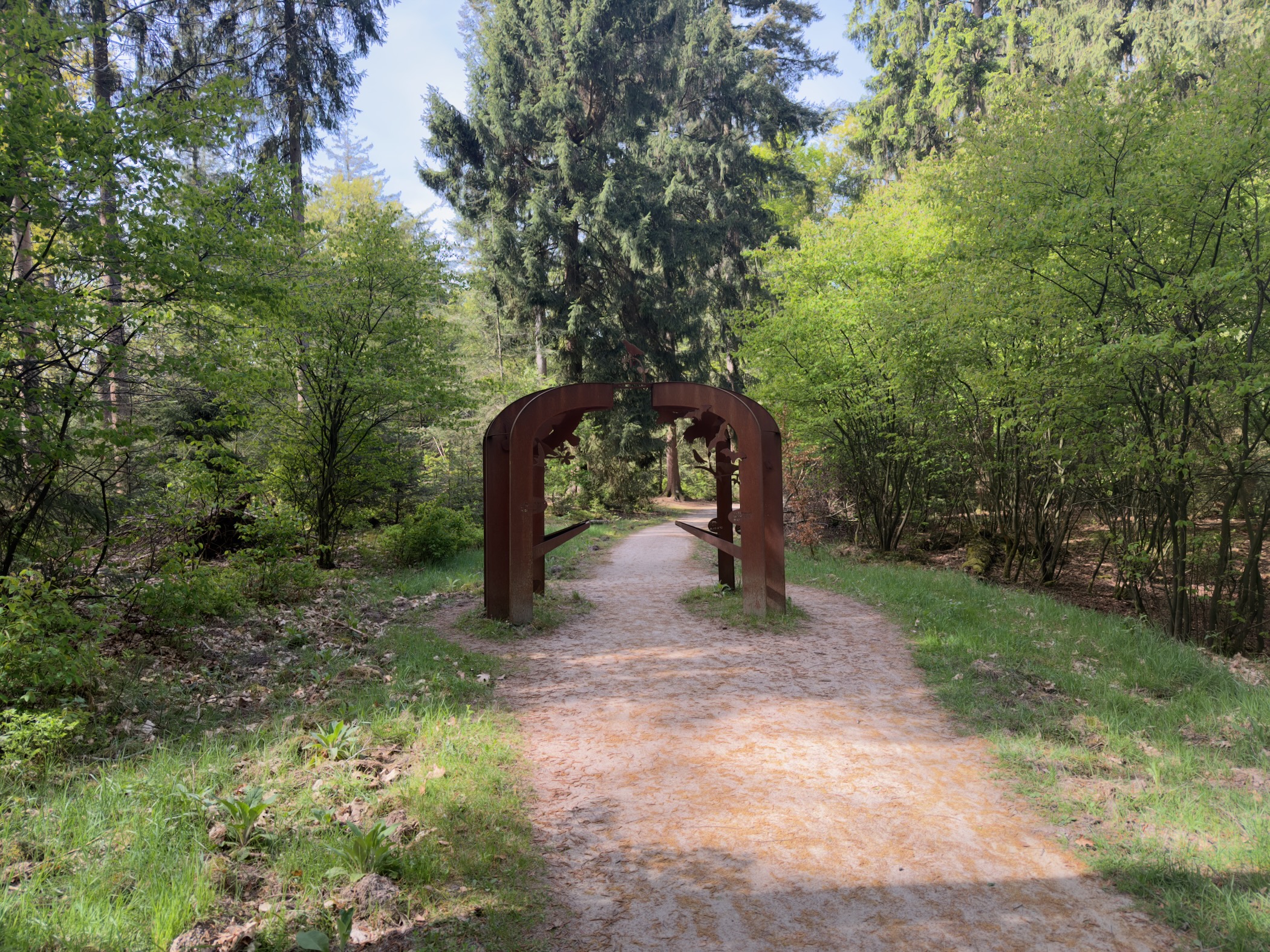 Wooden archway over a forest path