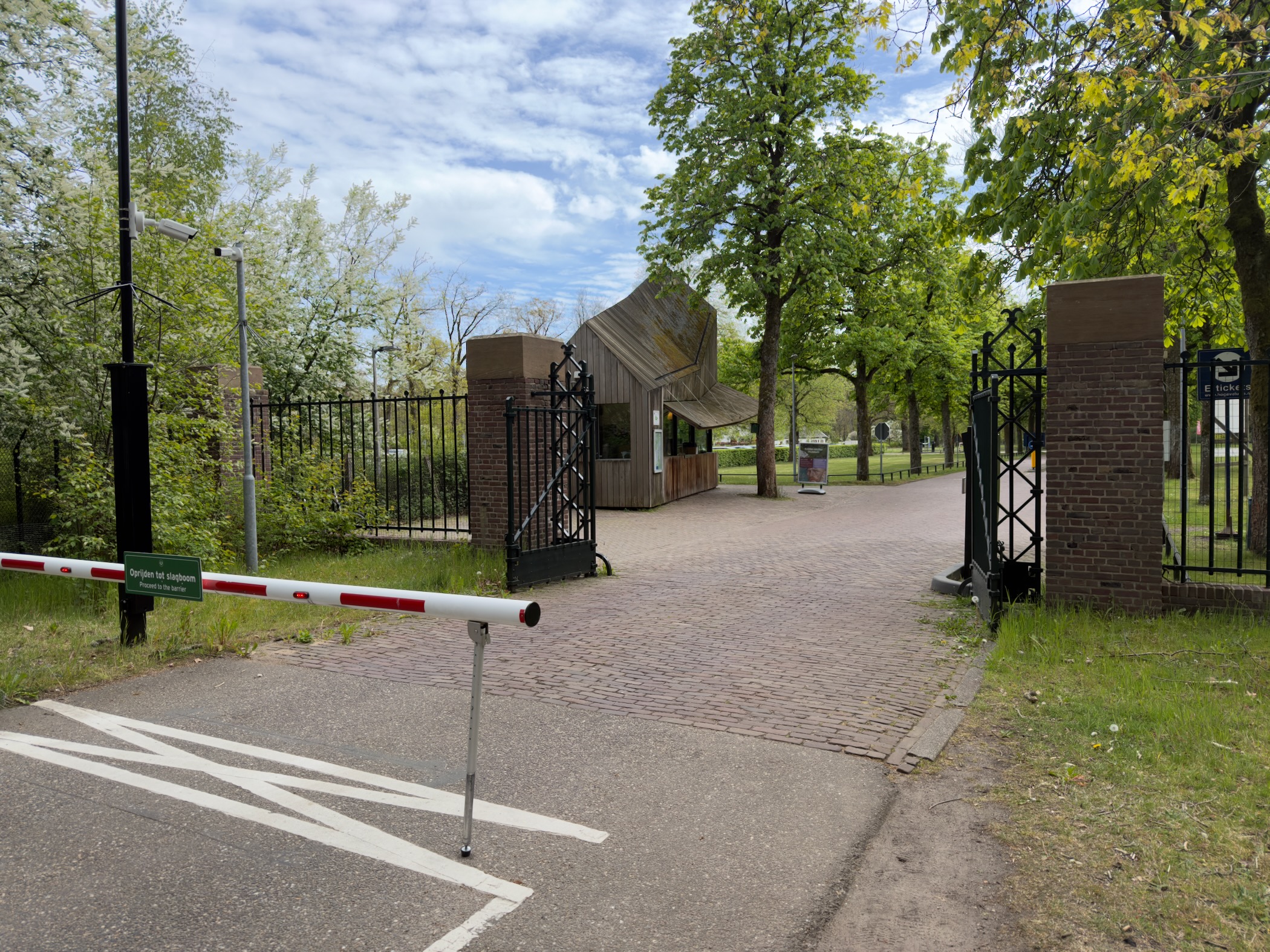 Park entrance gate with a barrier across the road